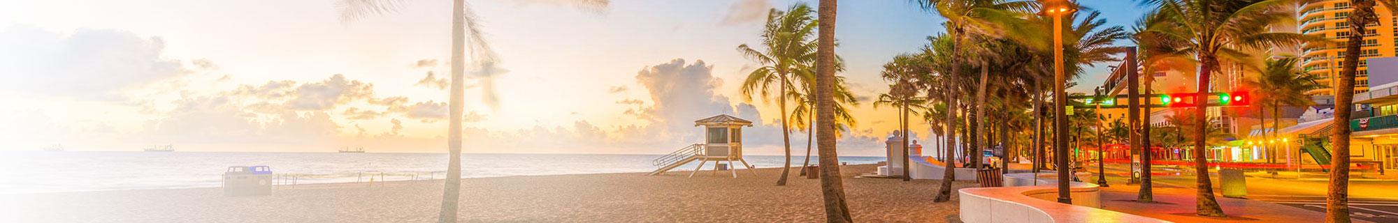 View of the beach with a lifeguard shack, next to a street